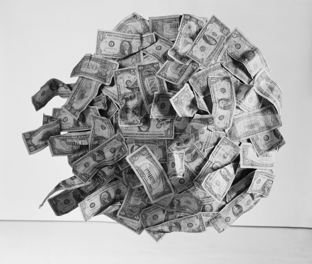 Scattered money representing a multi-trillion-dollar problem